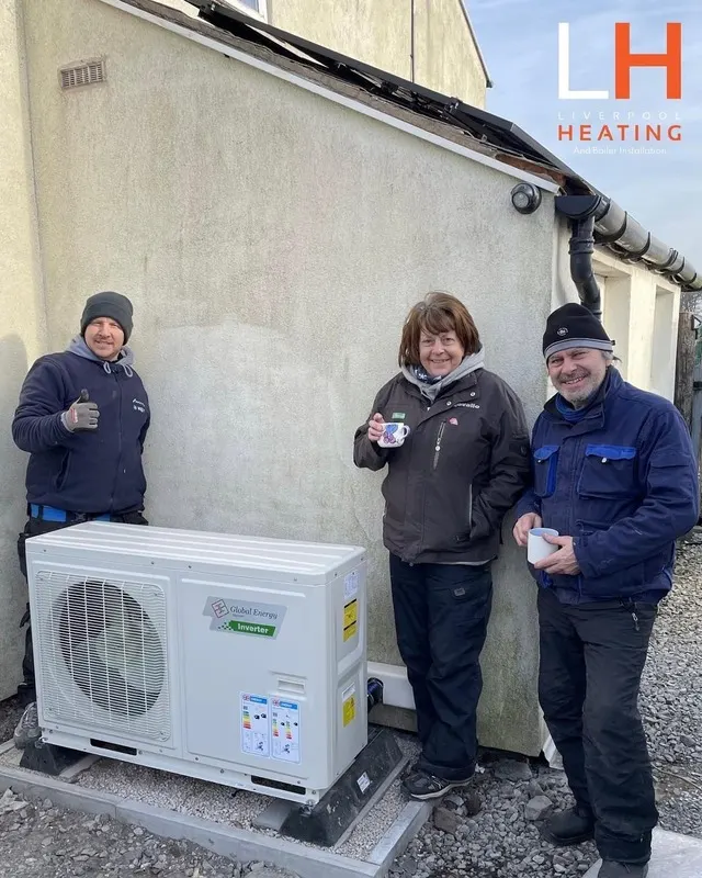 Homeowner and Liverpool Heating engineers with a cuppa beside a newly installed heat pump