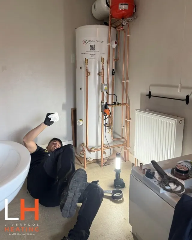 A Liverpool Heating engineer fitting the pipework for a heat pump hot water cylinder