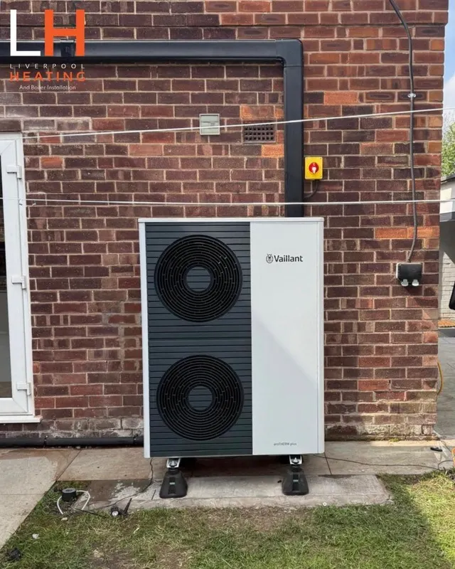 A Vaillant air source heat pump installed against a brick wall